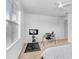 Bedroom featuring natural light from a window, a ceiling fan, and a home gym area at 6823 S Kissimmee St, Tampa, FL 33616