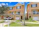 Charming townhouse showcasing a white balcony, neatly kept front lawn and convenient garage parking at 6823 S Kissimmee St, Tampa, FL 33616