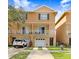 Inviting two-story townhome featuring a white balcony, attached garage, and manicured front lawn at 6823 S Kissimmee St, Tampa, FL 33616