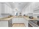 Bright kitchen with white cabinets, stainless steel appliances, and convenient layout for cooking at 6823 S Kissimmee St, Tampa, FL 33616
