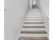 Bright staircase features white walls and wood-look steps at 6823 S Kissimmee St, Tampa, FL 33616