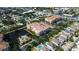 Comprehensive aerial view of condos surrounding a pond with community pool, plus residential neighborhood, offering a prime location at 7903 Seminole Blvd # 2103, Seminole, FL 33772