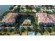 Breathtaking aerial view of condos surrounding a pond and pool, nestled in a vibrant community at 7903 Seminole Blvd # 2103, Seminole, FL 33772