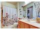 Bright bathroom with decorative shower curtain and wooden vanity at 7903 Seminole Blvd # 2103, Seminole, FL 33772