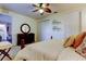 Bedroom with carpet, ceiling fan, iron bed frame, dresser, and stool at 7903 Seminole Blvd # 2103, Seminole, FL 33772
