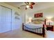 Bedroom with a decorative ceiling fan, carpet, and iron bed frame at 7903 Seminole Blvd # 2103, Seminole, FL 33772