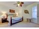 Bedroom with decorative ceiling fan, carpet, and iron bed frame at 7903 Seminole Blvd # 2103, Seminole, FL 33772