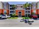 Elegant condo building exterior featuring lush landscaping, inviting entrance, and ample parking at 7903 Seminole Blvd # 2103, Seminole, FL 33772