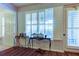 Foyer with hardwood floors, plantation shutters, console tables and wall decorations at 7903 Seminole Blvd # 2103, Seminole, FL 33772