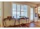 Foyer with hardwood floors, plantation shutters, console tables and wall decorations at 7903 Seminole Blvd # 2103, Seminole, FL 33772