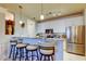 Open kitchen with bar seating, white cabinets, marble counters, and stainless steel appliances at 7903 Seminole Blvd # 2103, Seminole, FL 33772