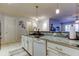 Kitchen view with granite counters, stainless appliances, white cabinetry, and tile floors at 7903 Seminole Blvd # 2103, Seminole, FL 33772