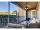 Relaxing screened lanai with comfortable seating and view of lush landscaping, ceiling fan, and neutral color scheme at 7903 Seminole Blvd # 2103, Seminole, FL 33772