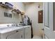 Efficient laundry room with modern washer and dryer, shelving, and ample space for laundry tasks and organization at 7903 Seminole Blvd # 2103, Seminole, FL 33772