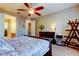 Stylish bedroom with dark wood furniture, ceiling fan, and ample natural light, creating a comfortable and inviting retreat at 7903 Seminole Blvd # 2103, Seminole, FL 33772