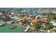 Beautiful waterfront property featuring a private dock, swimming pool, and lush tropical landscaping at 8014 12Th S Ave, St Petersburg, FL 33707