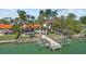 Rear view of home with a pool, dock, boat lift, and access to water for waterfront enjoyment at 8014 12Th S Ave, St Petersburg, FL 33707