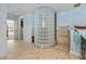 Unique bathroom design featuring a glass block shower wall, vanity, and neutral tiled floor at 8014 12Th S Ave, St Petersburg, FL 33707