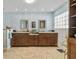 Spacious bathroom with double vanity, framed mirrors, and stylish wall decor, neutral tiled floor at 8014 12Th S Ave, St Petersburg, FL 33707