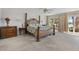 Spacious bedroom with wood furniture and views of the water from the sliding glass doors at 8014 12Th S Ave, St Petersburg, FL 33707