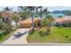 Beautiful single-story home with tile roof, landscaped front yard, and waterfront views in the background at 8014 12Th S Ave, St Petersburg, FL 33707