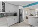 Modern kitchen featuring sleek white cabinetry, stainless steel appliances, and stylish backsplash at 8014 12Th S Ave, St Petersburg, FL 33707