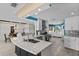 Bright kitchen with a large island, stainless steel appliances, and a view into the dining area at 8014 12Th S Ave, St Petersburg, FL 33707