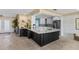 Spacious kitchen with dark island, light countertops, and a bar area with wine storage at 8014 12Th S Ave, St Petersburg, FL 33707