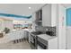 Modern kitchen featuring white cabinets, stainless steel appliances, and a stylish black and white backsplash at 8014 12Th S Ave, St Petersburg, FL 33707