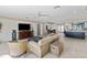 Bright living room with ceiling fan, water view, comfortable seating, open to dining and kitchen at 8014 12Th S Ave, St Petersburg, FL 33707