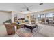 Comfortable living room with water view, ceiling fan, and access to the patio and pool at 8014 12Th S Ave, St Petersburg, FL 33707