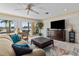 Cozy living room with water view, ceiling fan, comfortable seating, and access to the patio at 8014 12Th S Ave, St Petersburg, FL 33707