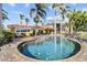 Inviting backyard pool and spa with a brick-paved deck, surrounded by lush tropical landscaping at 8014 12Th S Ave, St Petersburg, FL 33707