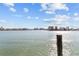 Scenic waterfront view showcasing the calm water and distant buildings with a wood piling in view at 8014 12Th S Ave, St Petersburg, FL 33707