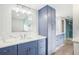 Elegant Primary bath with double vanity, marble countertops, and a view of the glass shower at 8439 Boxwood Dr, Tampa, FL 33615