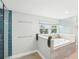Bright bathroom with a soaking tub, glass shower, and a view of the exterior through a window at 8439 Boxwood Dr, Tampa, FL 33615