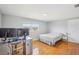 Bedroom with hardwood floors and large window, featuring a dedicated workspace at 8439 Boxwood Dr, Tampa, FL 33615