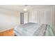 Spacious bedroom with hardwood floors, neutral walls, ceiling fan, and double closets at 8439 Boxwood Dr, Tampa, FL 33615