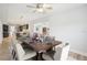 Staged dining room with seating for eight and an open floorplan to the kitchen at 8439 Boxwood Dr, Tampa, FL 33615