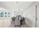 Bright dining room featuring a decorative rug, modern lighting, and white walls at 8439 Boxwood Dr, Tampa, FL 33615