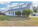 The two-story home features a unique roof, well-manicured lawn and beautiful landscaping at 8439 Boxwood Dr, Tampa, FL 33615