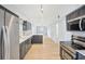 Spacious kitchen with modern finishes, stainless appliances, and open layout to living area at 8439 Boxwood Dr, Tampa, FL 33615