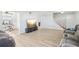 Open-concept living area with new light wood-like floors, fresh paint, and staircase at 8439 Boxwood Dr, Tampa, FL 33615