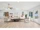 Spacious living room with a large sectional sofa, bright windows, and modern decor at 8439 Boxwood Dr, Tampa, FL 33615