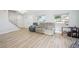 Bright and open living room features a staircase, new light wood-like floors, and fresh paint at 8439 Boxwood Dr, Tampa, FL 33615