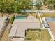 Expansive backyard with a screened pool, lush landscaping, and outdoor seating area, perfect for relaxation at 9069 Gaynor St, Spring Hill, FL 34608
