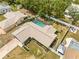 Sprawling property with a screened pool, lush landscaping, and multiple outdoor living spaces at 9069 Gaynor St, Spring Hill, FL 34608