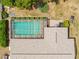 Aerial view showcasing the screened pool, lush landscaping, and the layout of the home's backyard at 9069 Gaynor St, Spring Hill, FL 34608