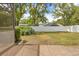 Large, grassy backyard enclosed by a white fence, perfect for outdoor activities at 9069 Gaynor St, Spring Hill, FL 34608