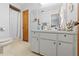 Cozy bathroom with tiled flooring, single sink, and shower behind curtain at 9069 Gaynor St, Spring Hill, FL 34608